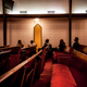 Five men sit listening to their family and friends sing in the 12th District Mass Choir at the Bethel A.M.E. Church, in Little Rock, Arkansas, 2015.